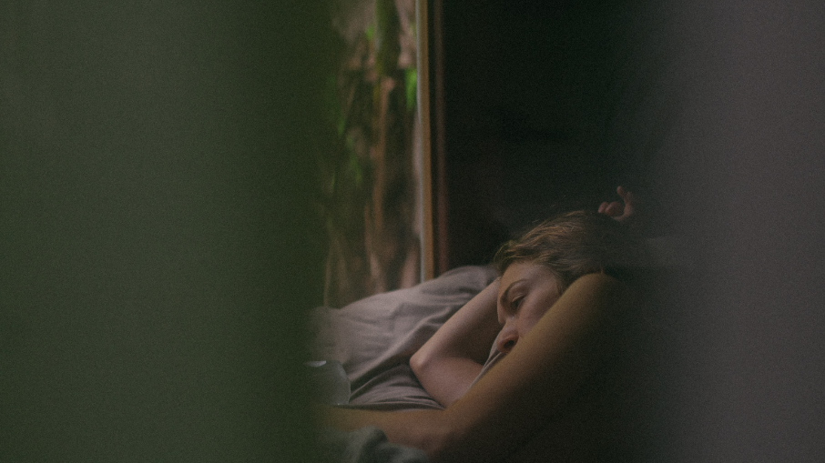 Girl lying in bed with open window