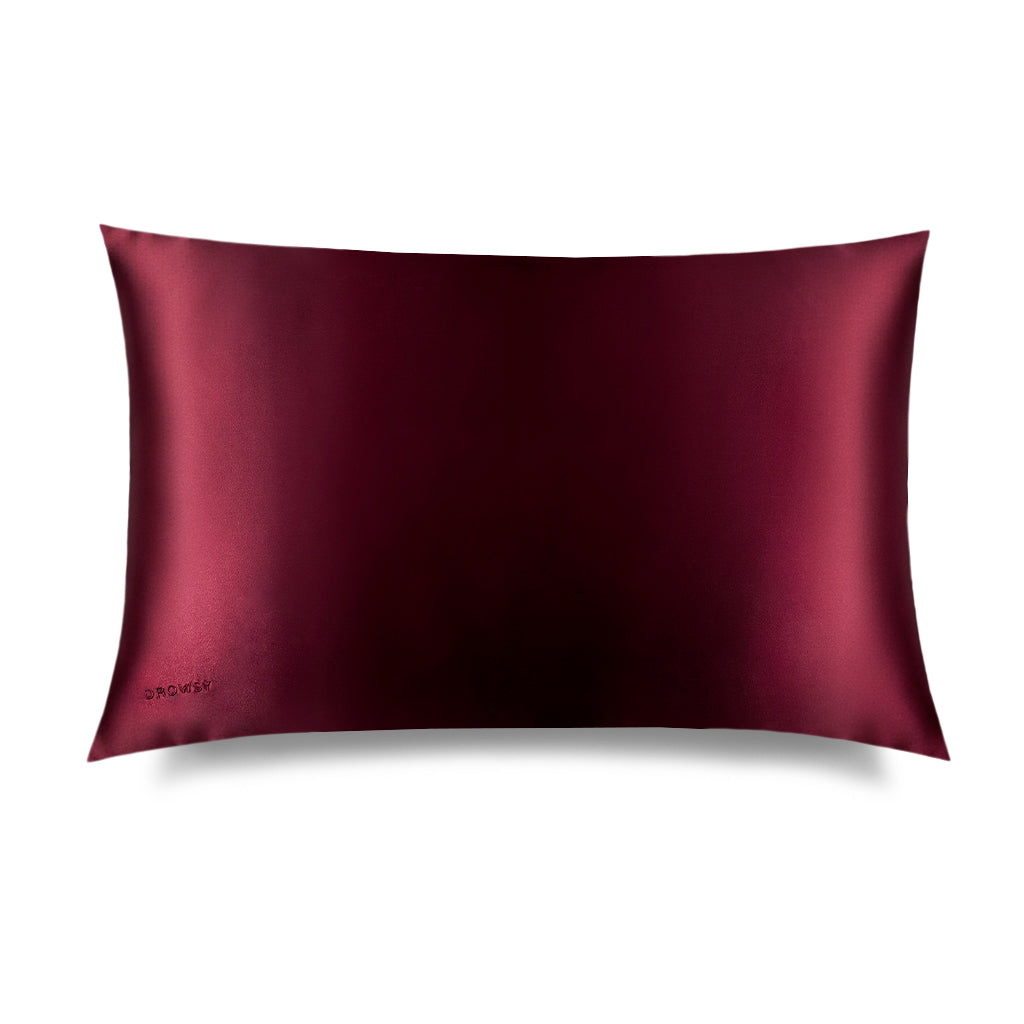 The La Vie En Rouge Silk Pillowcase by drowsysleepco, in deep burgundy with a smooth, shiny finish, is shown on a white background—a beauty and skincare must-have that protects hair.