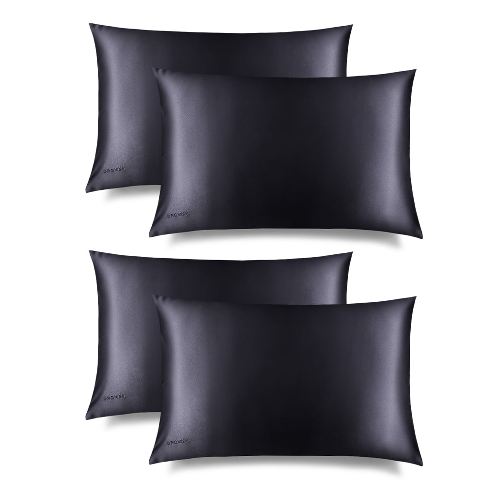Four Moonlight Shadow Silk Pillowcases by drowsysleepco, a skincare and beauty essential, are arranged in two rows on a white background. Each smooth pillowcase features hair-protecting silk and a subtle embroidered brand logo in the corner.
