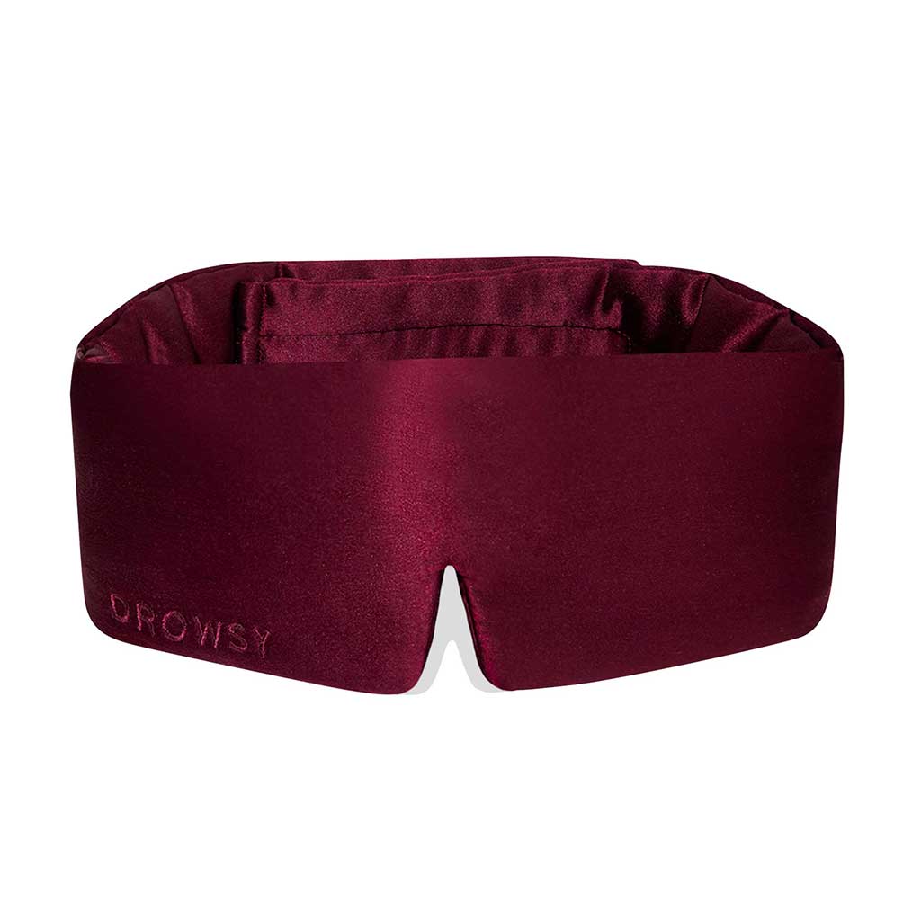 Experience ultimate beauty sleep with drowsysleepcos La Vie En Rouge—a luxurious, deep burgundy silk sleep mask featuring a subtle “DROWSY” logo, plush blackout padding, and a comfortable center notch.