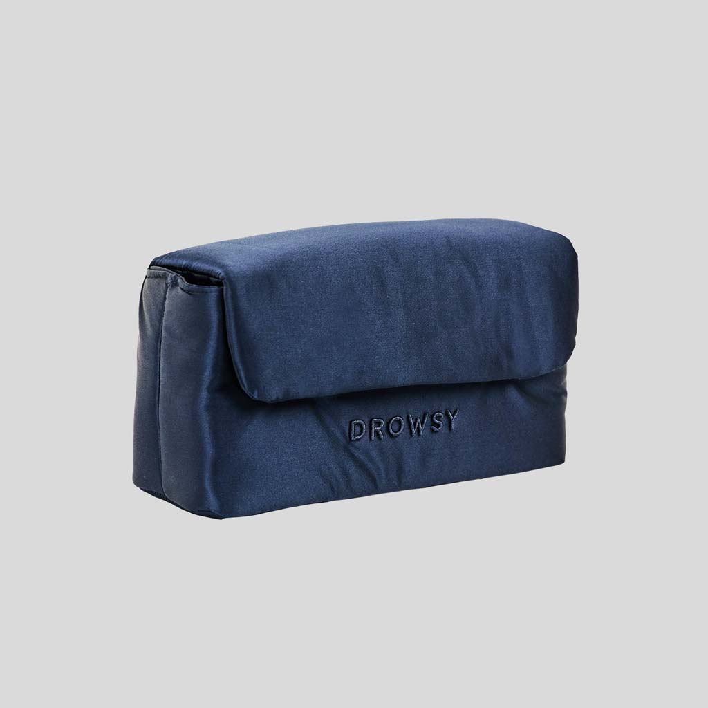 The Drowsy Silk Necessaire in Midnight Blue is a rectangular silk pouch with flap closure and DROWSY embroidery—an elegant accessory by Drowsy, shown on a plain light gray background.
