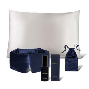 The drowsysleepco Midnight Ritual Bundle includes a Midnight Blue Sleep Mask, an Akoya Pearl Silk Pillowcase, a spray bottle, a box, and a matching Silk Carry Pouch—all elegantly arranged on a white background.