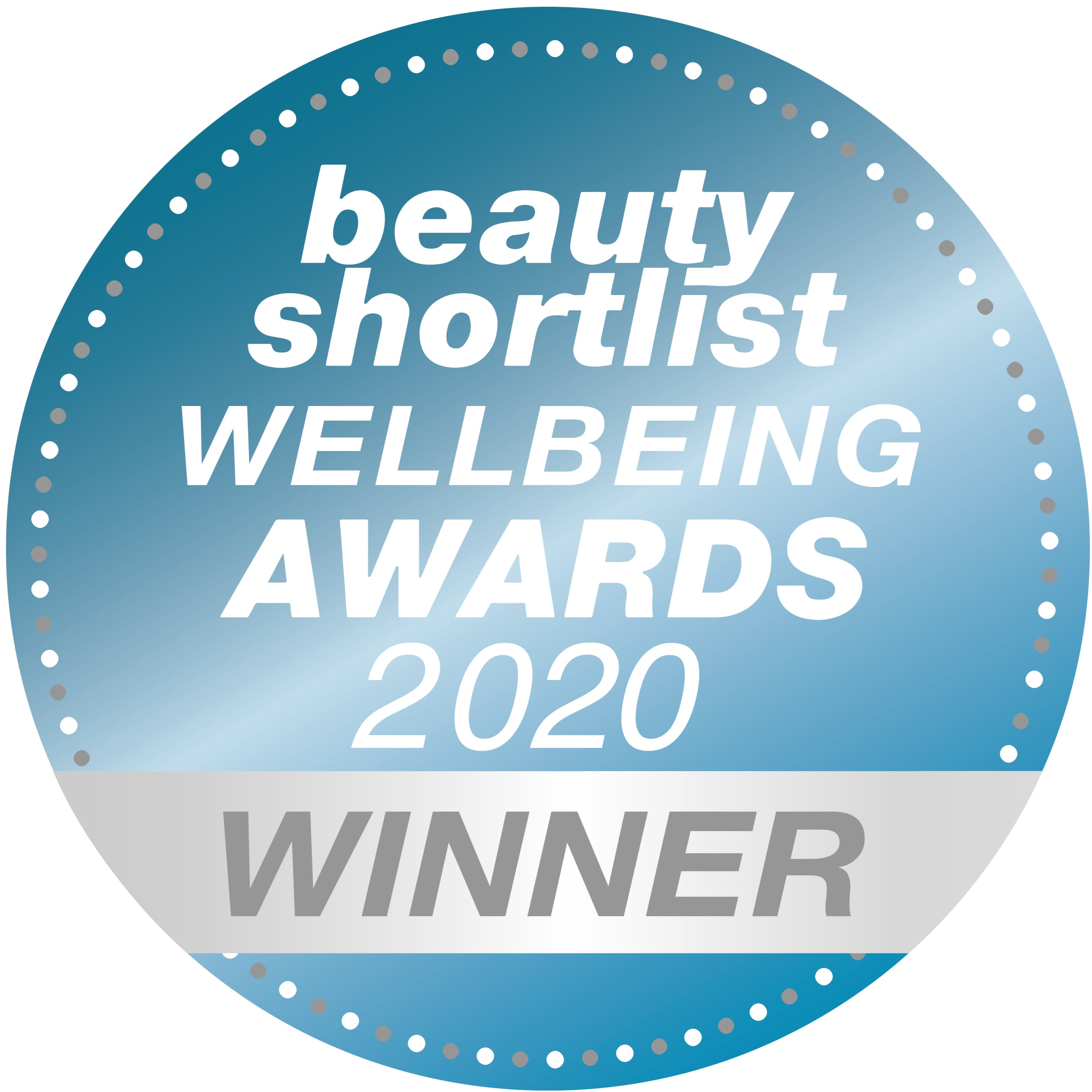 A blue circular badge with silver dots around the edge reads beauty shortlist WELLBEING AWARDS 2020 WINNER in white and silver text.