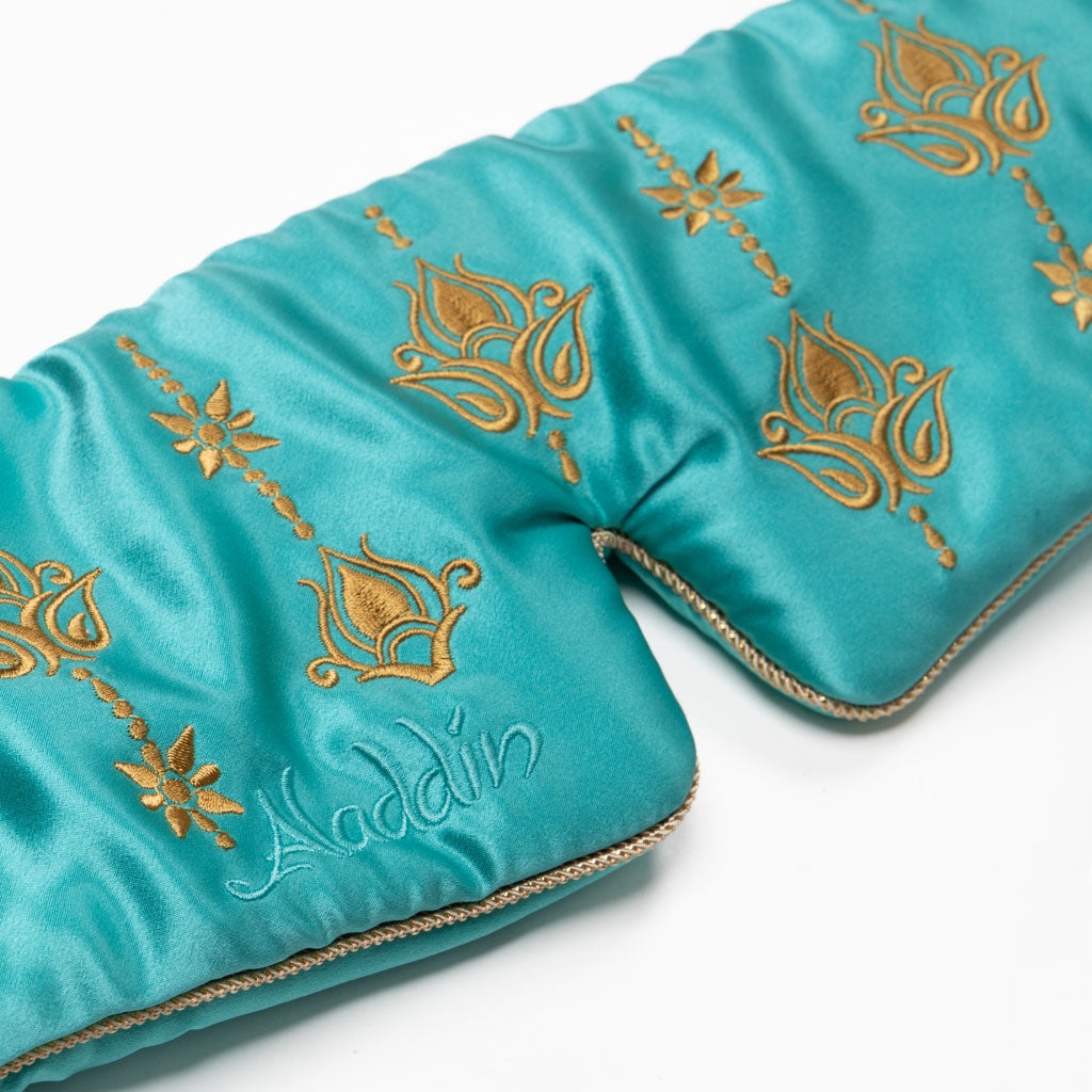 The Jasmine Sleep Mask by drowsysleepco is a teal satin eye mask featuring gold floral embroidery and "Aladdin" in elegant script, displayed on a white background.