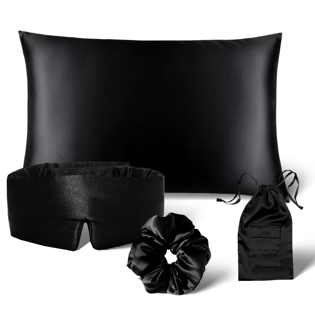 The Sensual sleep bundle - Black Jade by drowsysleepco, featuring a black satin Silk Pillowcase, Silk Sleep Mask, scrunchie, and drawstring pouch, is elegantly displayed on a white background.