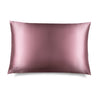 The Damask Rose Silk Pillowcase by drowsysleepco is a rectangular, mauve-colored pillowcase with a subtle sheen. "DROWSY" is printed in small letters in one corner, making it an ideal hair and skin care essential.