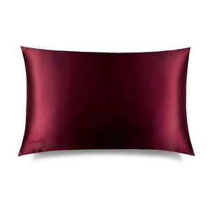 The La Vie En Rouge Silk Pillowcase by drowsysleepco, in deep burgundy with a smooth, shiny finish, is shown on a white background—a beauty and skincare must-have that protects hair.