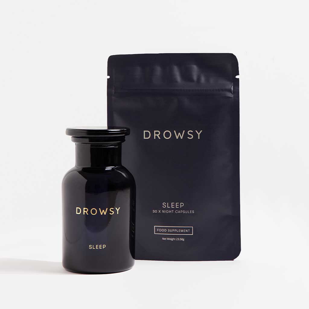 A dark glass bottle and resealable pouch, both labeled Supplements - Sleep by drowsysleepco, are shown against a plain white background. These supplements promote relaxation for a refreshed wake-up each morning.