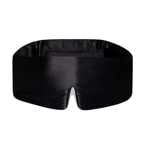 The Black Jade by drowsysleepco is a black silk, contoured eye mask with a subtle notch at the bottom center. “DROWSY” is elegantly embossed on the lower left, making it a stylish blackout sleep mask designed for beauty rest.