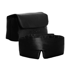 The Drowsy Sleepover bundle - Black Jade features a contoured black silk sleep mask and a matching storage pouch with a flap closure, both boasting a smooth, shiny finish. The pouch is printed with Drowsy.