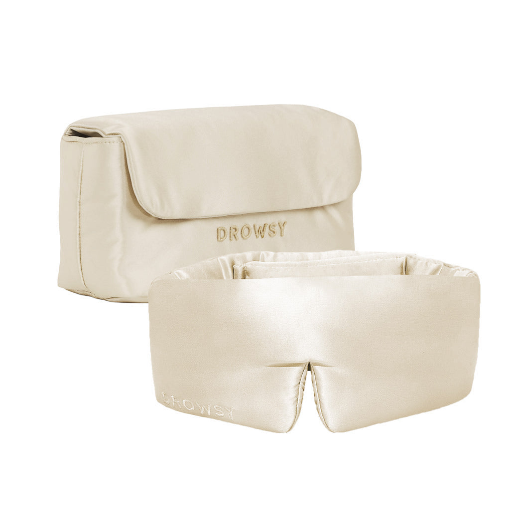 The Drowsy Sleepover bundle in Dusty Gold features a silk sleep mask and matching necessaire pouch, both embroidered with the Drowsy logo, adding luxury to your nightly routine and showcased on a white background.