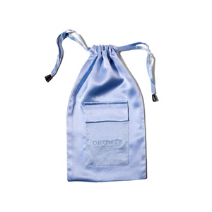 The Blue Belle Silk Carry Pouch by drowsysleepco is a light blue mulberry silk pouch with a drawstring, front pocket, and DROWSY embroidery, shown against a white background.