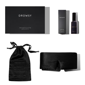 The Black Jade Deep Sleep Collection by drowsysleepco includes a luxury silk sleep mask, black branded box, small drawstring pouch, and deep sleep pillow spray with its box, all beautifully arranged on a white background.