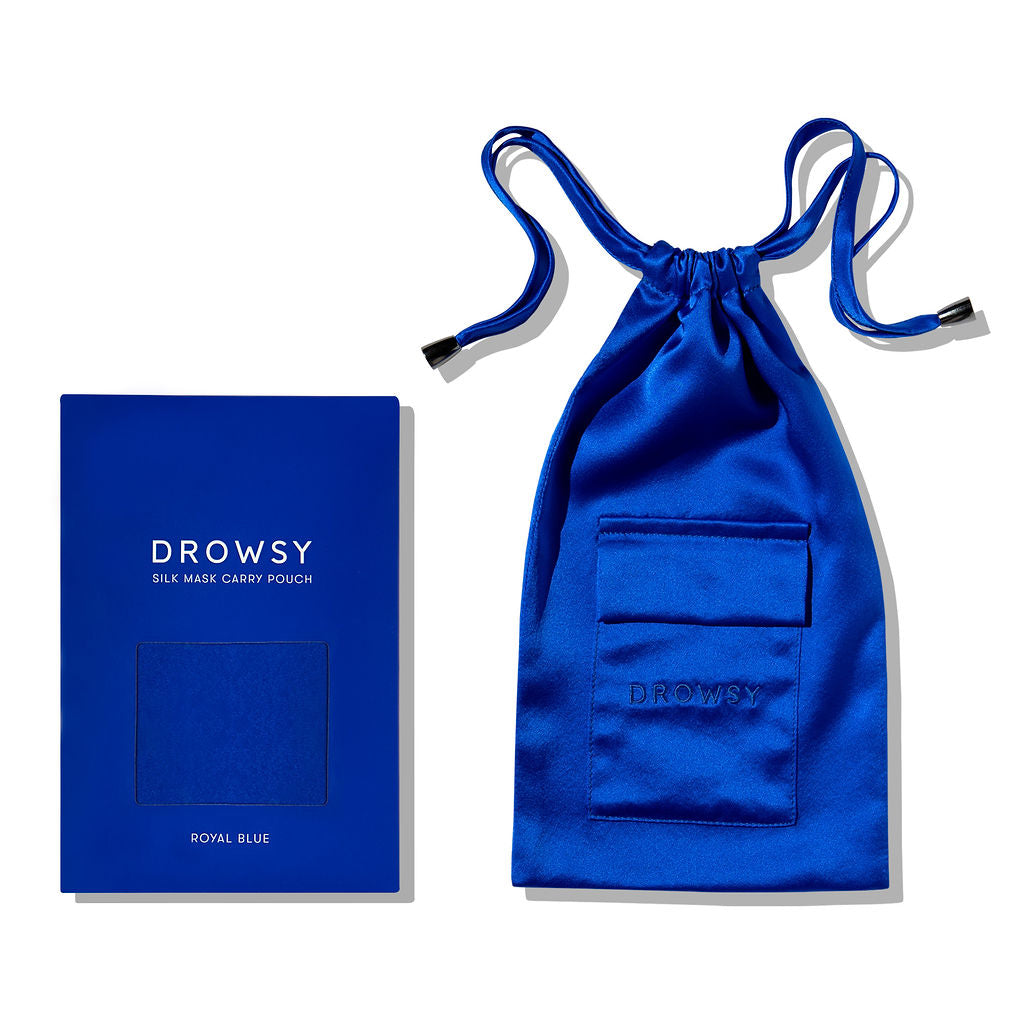 A Royal Blue Silk Carry Pouch by drowsysleepco, featuring a pocket and drawstring closure, is shown next to its matching box labeled Royal Blue Silk Carry Pouch, ideal for storing your silk sleep mask.