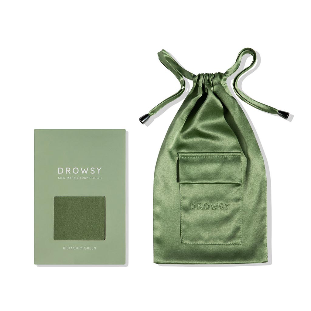 A pale green box labeled Pistachio Green Silk Carry Pouch by drowsysleepco sits beside a matching mulberry silk drawstring pouch, both displayed on a white background.
