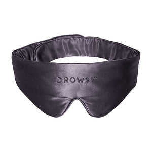 Introducing the Moonlight Shadow Featherweight Silk Sleep Mask by drowsysleepco, a luxurious blackout eye mask crafted from black mulberry silk. This silky sleep mask features the drowsysleepco logo elegantly embroidered on the front and is showcased against a crisp white background.