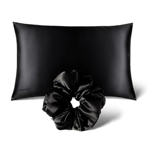 The Perfect hair bundle Black Jade by drowsysleepco features a black silk pillowcase paired with a matching silk scrunchie, both elegantly displayed against a crisp white background.