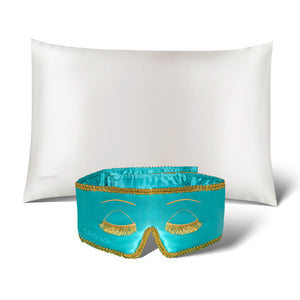 The Perfect Skin Bundle Breakfast at Drowsy by drowsysleepco showcases a white silk pillowcase and a turquoise sleep mask with gold embroidered eyelashes, set against a white background—ideal for elevating your beauty sleep.